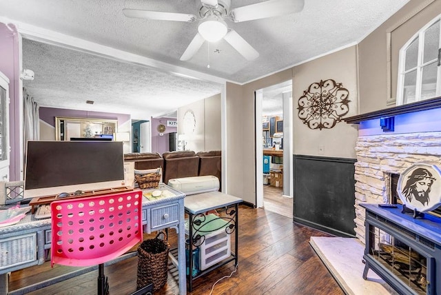 131 W Blue Branch Rd, Eatonton, GA 31024 - home office with a textured ceiling, a wood stove, a ceiling fan, and wood-type flooring