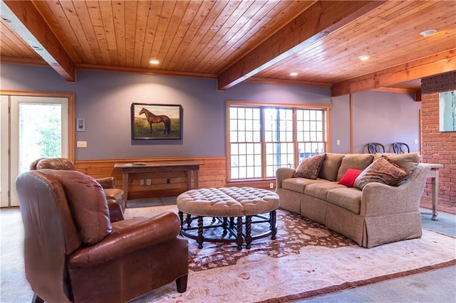 carpeted living room featuring beamed ceiling, wooden walls, and wooden ceiling