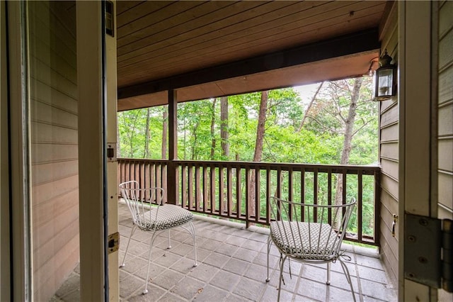 unfurnished sunroom with wood ceiling