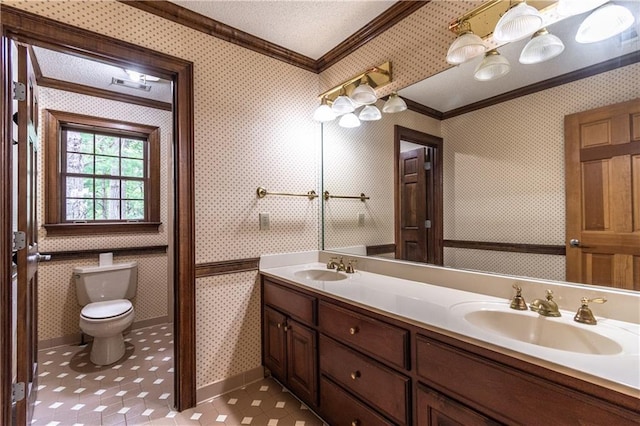 bathroom featuring tile patterned flooring, a textured ceiling, toilet, vanity, and ornamental molding