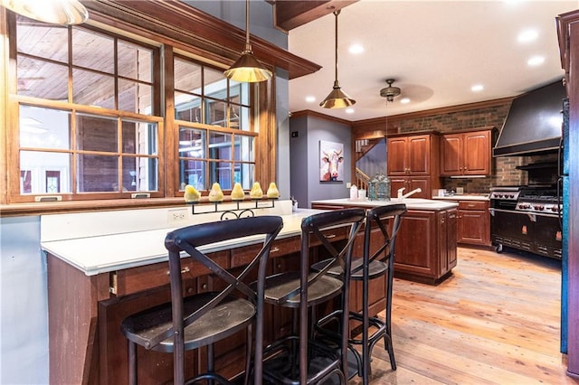 interior space featuring ornamental molding, brick wall, custom range hood, pendant lighting, and light hardwood / wood-style flooring