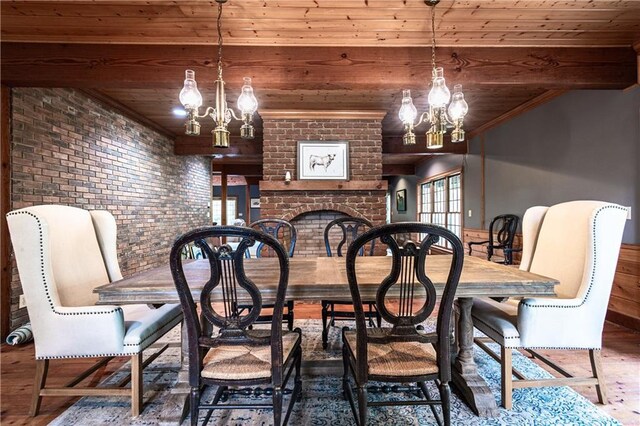 dining room with wood-type flooring, wood ceiling, a notable chandelier, and brick wall