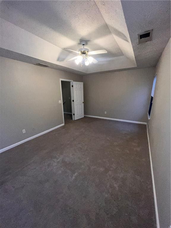 142 Benfield Cir, Cartersville, GA 30121 - unfurnished bedroom with ceiling fan, dark carpet, a textured ceiling, and a tray ceiling