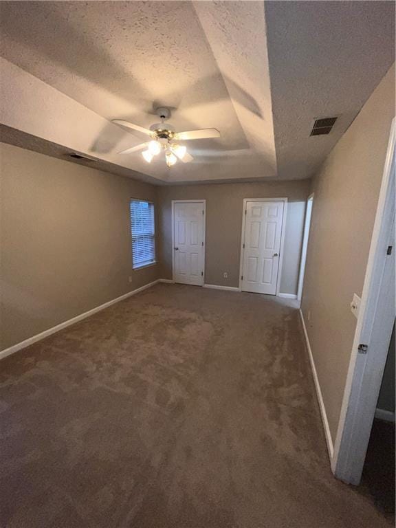 142 Benfield Cir, Cartersville, GA 30121 - unfurnished bedroom with ceiling fan, a tray ceiling, a textured ceiling, and carpet flooring