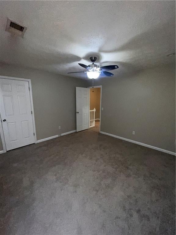 142 Benfield Cir, Cartersville, GA 30121 - unfurnished bedroom featuring a textured ceiling, ceiling fan, and dark colored carpet