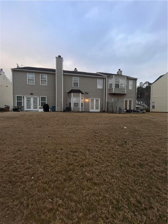 142 Benfield Cir, Cartersville, GA 30121 - back of house with central AC and a lawn