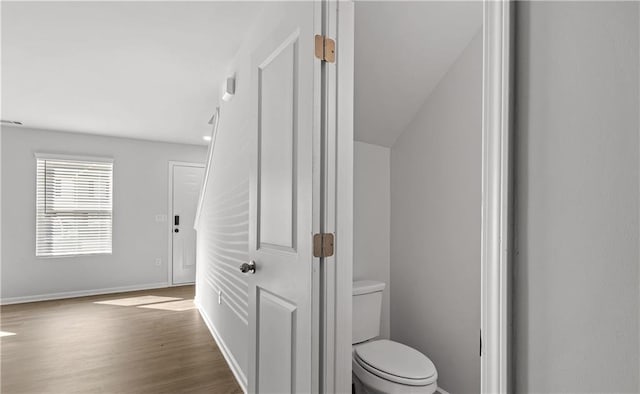 bathroom with wood-type flooring and toilet