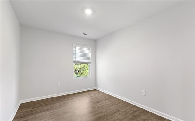 empty room with dark hardwood / wood-style floors