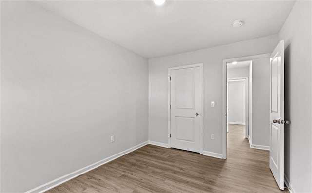 unfurnished bedroom featuring hardwood / wood-style flooring