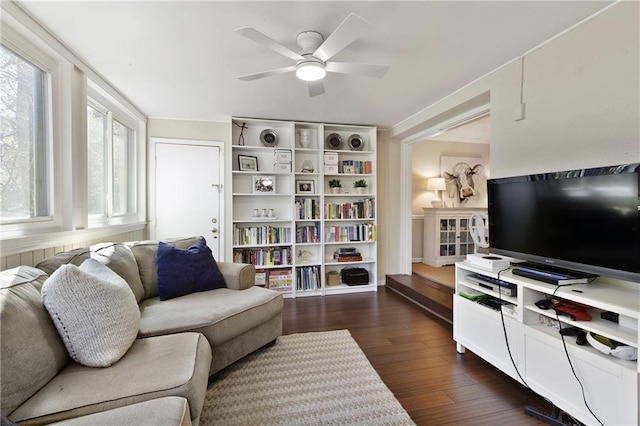 living room featuring dark wood finished floors and a ceiling fan