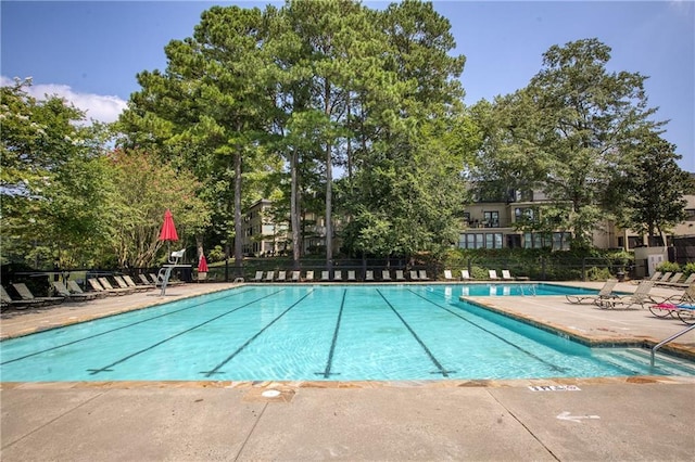 community pool featuring fence and a patio