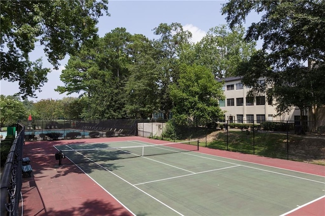 view of sport court featuring fence