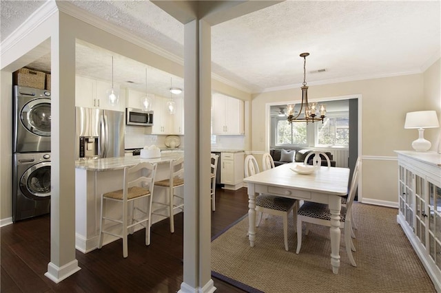 dining area with stacked washer and dryer, crown molding, a textured ceiling, and dark wood-type flooring