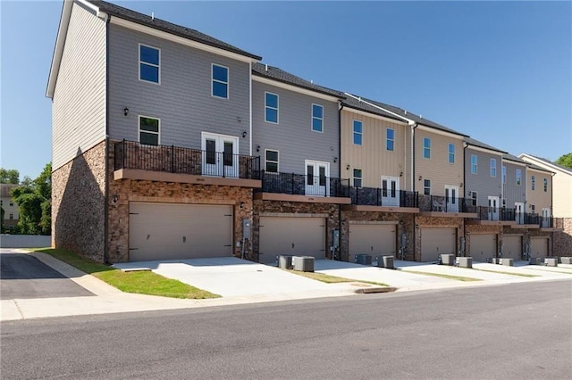 3810 Jack Vernon Cir, Powder Springs, GA 30127 - rear view of house featuring french doors, a balcony, a residential view, an attached garage, and stone siding