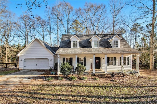 cape cod home featuring a porch and a garage