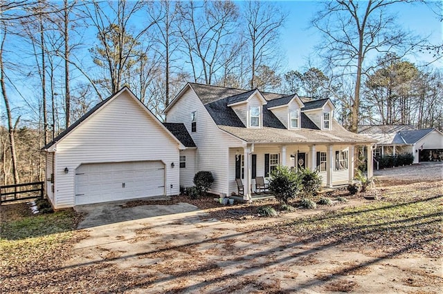 cape cod-style house with a garage and a porch