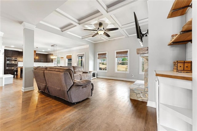 living room featuring ornamental molding, coffered ceiling, dark wood-style floors, baseboards, and ceiling fan