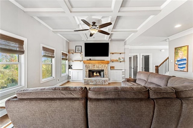 living room with light wood finished floors, crown molding, beam ceiling, a fireplace, and coffered ceiling