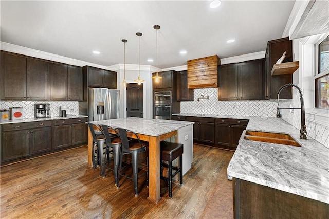 kitchen featuring a sink, dark brown cabinets, stainless steel appliances, and open shelves