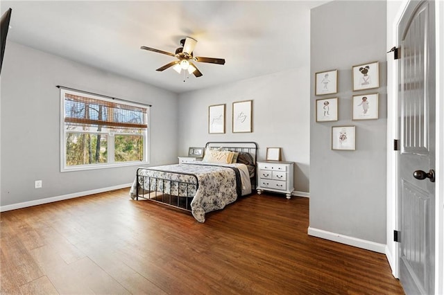 bedroom featuring dark wood finished floors, ceiling fan, and baseboards