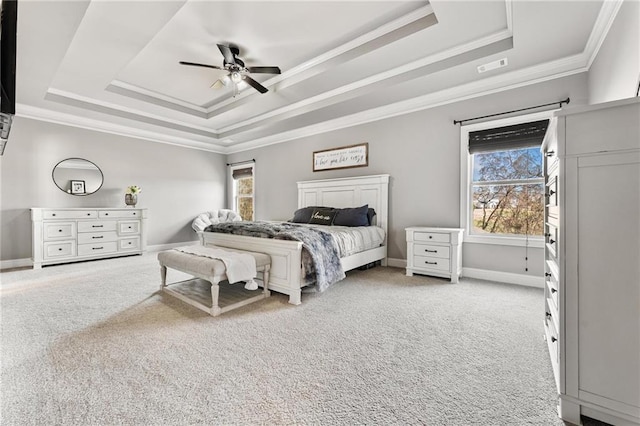 bedroom with visible vents, a raised ceiling, and light colored carpet