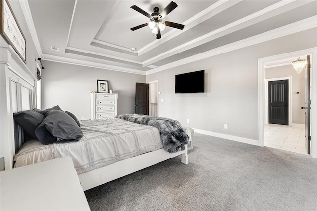 bedroom featuring visible vents, crown molding, baseboards, carpet flooring, and a raised ceiling