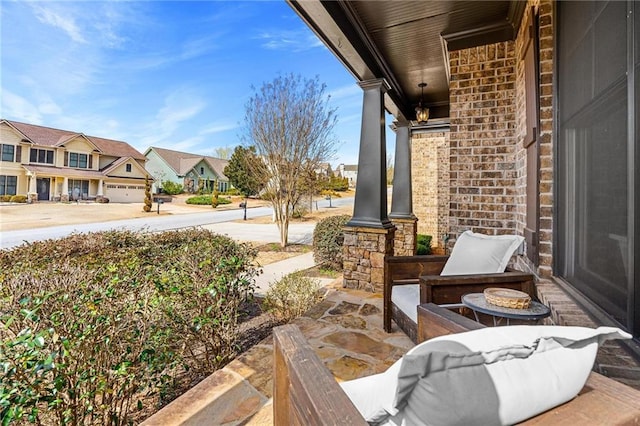 view of patio with a residential view and a porch