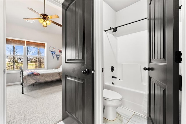 ensuite bathroom featuring visible vents, toilet, a ceiling fan, ensuite bath, and bathtub / shower combination