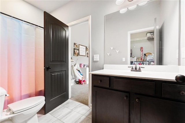 bathroom with toilet and vanity