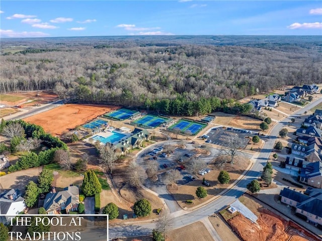 bird's eye view with a wooded view