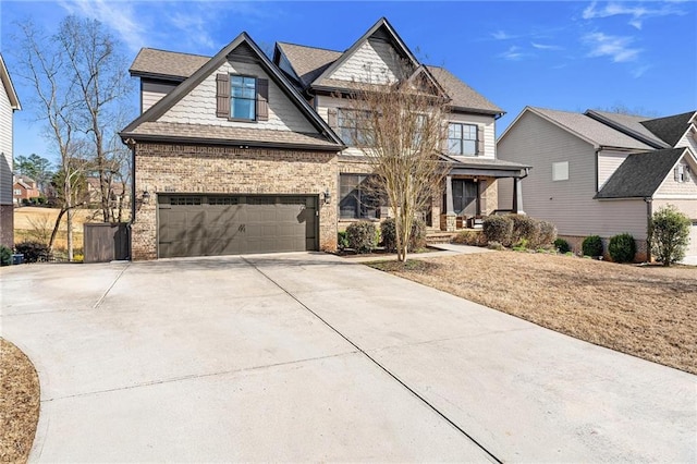 craftsman-style house featuring a garage, brick siding, and driveway