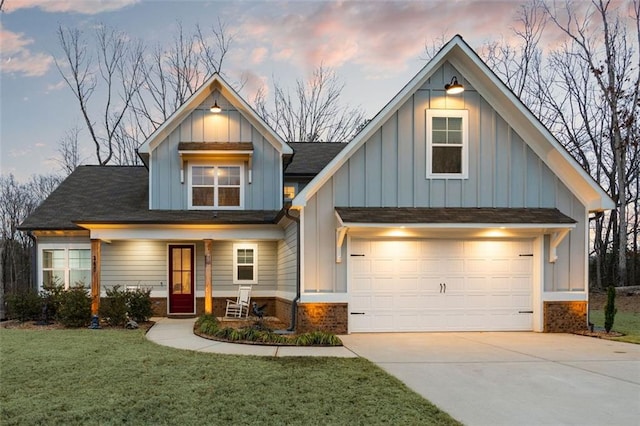 view of front of house featuring a garage, a porch, and a lawn