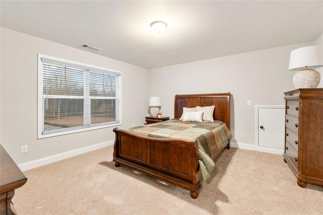 bedroom with carpet, visible vents, and baseboards