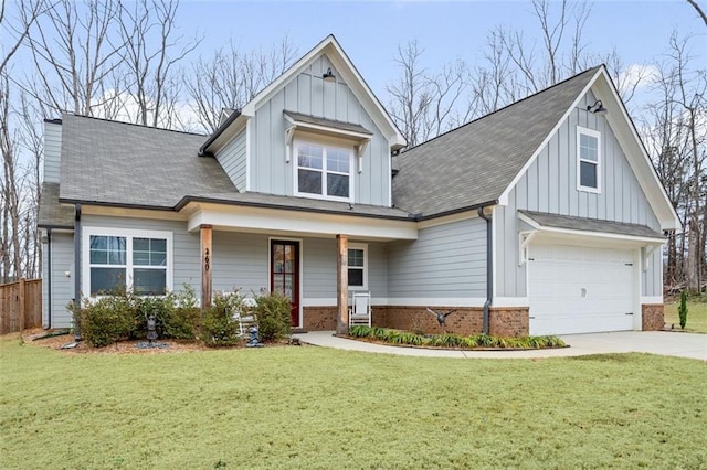 view of front of property with a garage, brick siding, concrete driveway, board and batten siding, and a front yard