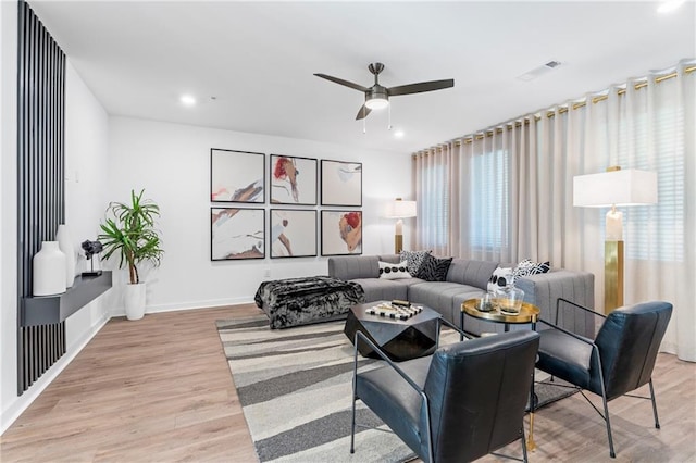 living room featuring ceiling fan and light wood-type flooring