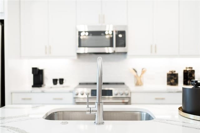 kitchen with white cabinets and light stone counters