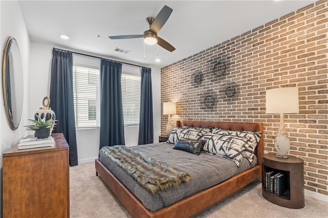 carpeted bedroom featuring ceiling fan and brick wall