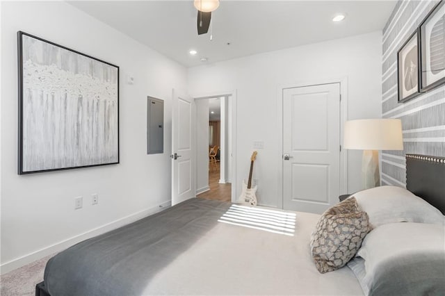 bedroom with electric panel, ceiling fan, and carpet floors