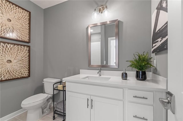 bathroom with tile patterned flooring, vanity, and toilet