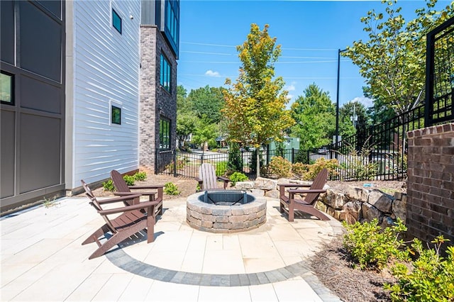 view of patio / terrace featuring an outdoor fire pit