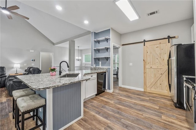 58 Hampton Forest Ct, Dahlonega, GA 30533 - kitchen with a sink, appliances with stainless steel finishes, a barn door, wood finished floors, and recessed lighting