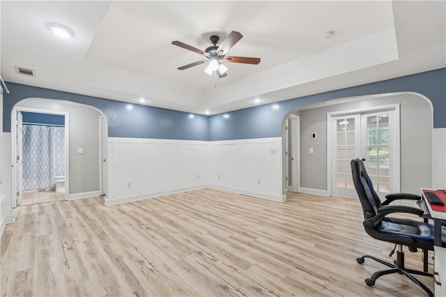 58 Hampton Forest Ct, Dahlonega, GA 30533 - office featuring arched walkways, a tray ceiling, a ceiling fan, light wood-style floors, and a wainscoted wall