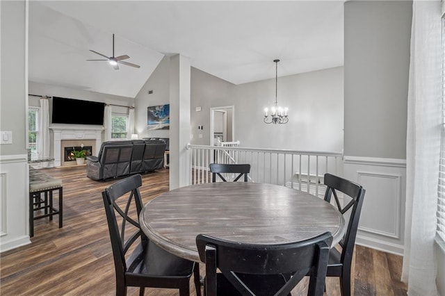 58 Hampton Forest Ct, Dahlonega, GA 30533 - dining space featuring wainscoting, dark wood-type flooring, a fireplace, a ceiling fan, and a chandelier