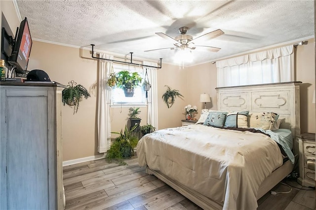 315 Charlotte Blvd, Stockbridge, GA 30281 - bedroom with a textured ceiling, light wood-style floors, crown molding, ceiling fan, and baseboards
