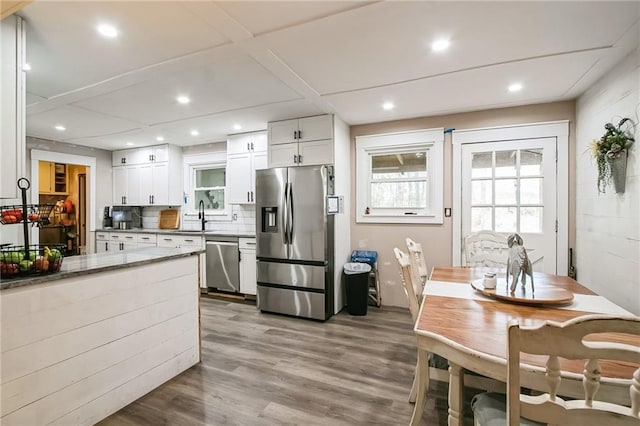 315 Charlotte Blvd, Stockbridge, GA 30281 - kitchen with stainless steel appliances, a sink, recessed lighting, light wood-type flooring, and white cabinets