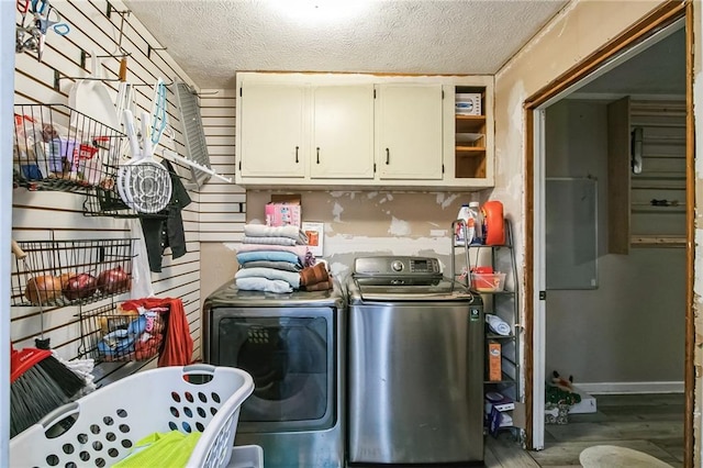315 Charlotte Blvd, Stockbridge, GA 30281 - clothes washing area with cabinet space, washing machine and clothes dryer, a textured ceiling, and wood finished floors