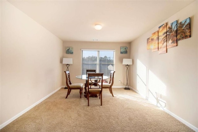 dining room with light carpet