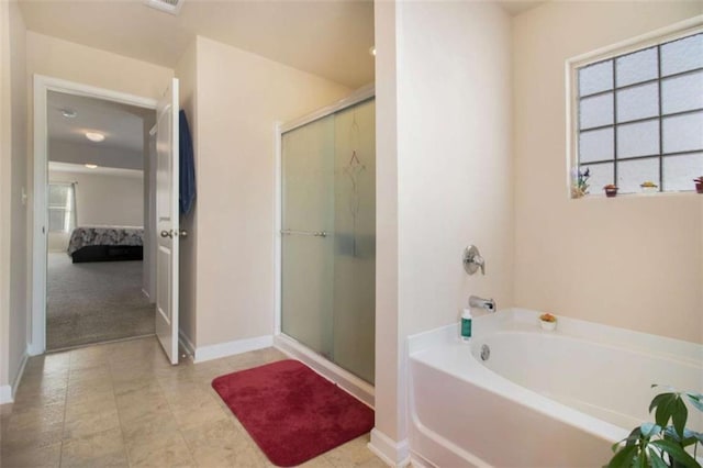 bathroom featuring separate shower and tub