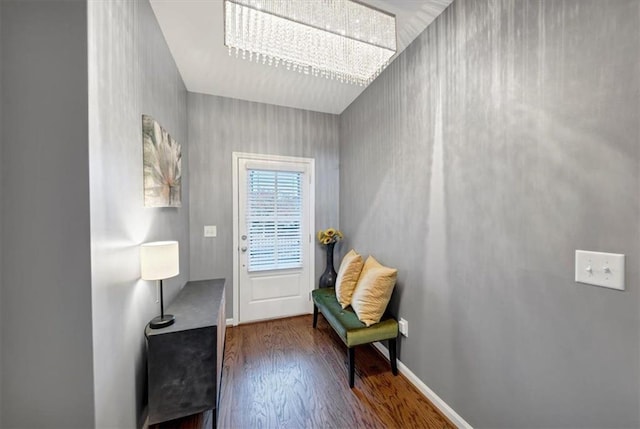 living area featuring hardwood / wood-style floors and a chandelier