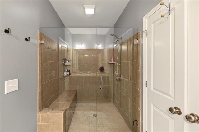 bathroom featuring a shower with door